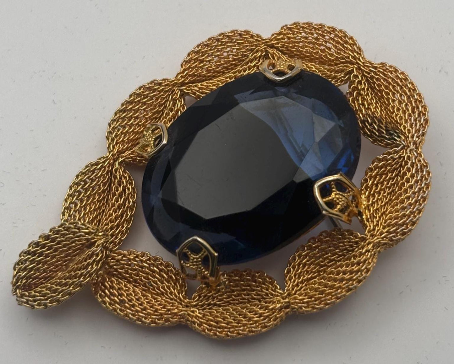 Gold Tone Mesh Brooch with Large Blue Crystal Stone