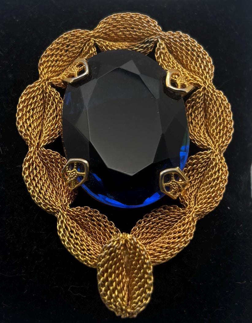 Gold Tone Mesh Brooch with Large Blue Crystal Stone