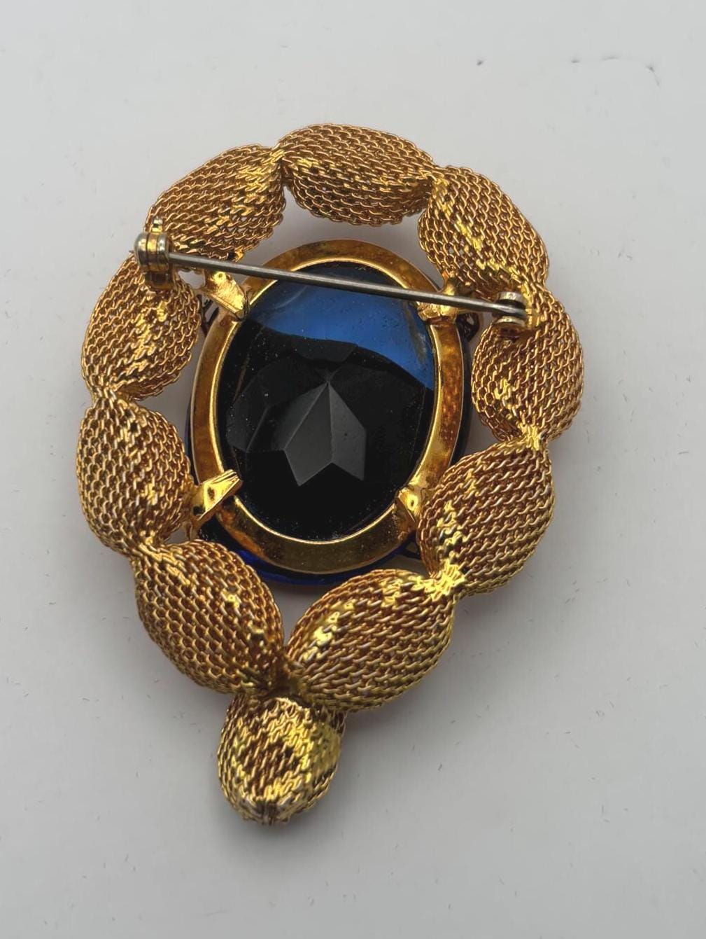 Gold Tone Mesh Brooch with Large Blue Crystal Stone